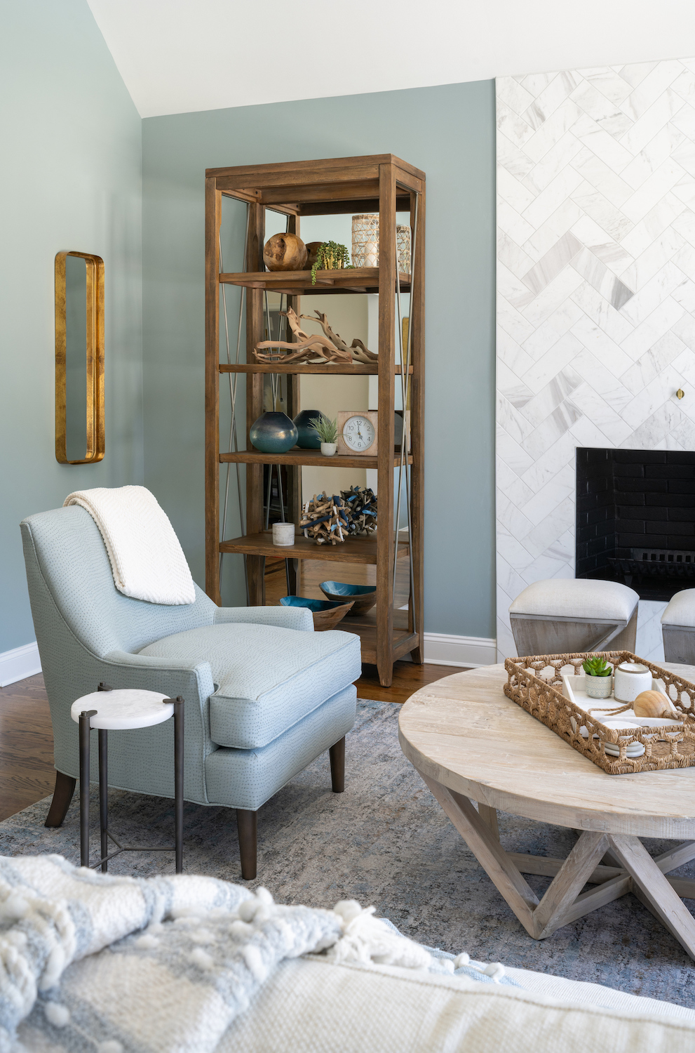 Adding personality to your home. Beautiful living room featuring a herringbone fireplace and statement arm chairs.